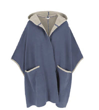 Load image into Gallery viewer, Deze poncho van Cycleur de Luxe biedt zowel stijl als sportiviteit. Deze poncho heeft lichtblauw als basiskleur met grijze accenten en is vervaardigd van een luxe mix. Met een eigentijdse capuchon en boeiende kleurvlakken aan de binnenkant zet poncho LAURA de trend. Deze cape poncho zorgt voor ongeëvenaard comfort en een lange levensduur en toont de kunst van de mondiale mode. Ontdek de perfecte aanvulling op jouw garderobe, is perfect te combineren met de prachtige LENA trui.