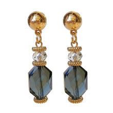 Load image into Gallery viewer, Blauwe statement oorbellen uit de Veerle Collectie! Deze oorbel is een echte eyecatcher. De oorbellen zijn gemaakt van geslepen kristal en zijn ook nog eens gold dipped. De oorbel is verkrijgbaar in verschillende kleuren: zwart, beige, paars, blauw. De afmeting van de oorbel is 4,7cm x 1cm.
