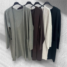 Afbeelding in Gallery-weergave laden, Lange Vesten Mae Knitwear, met luxe rijgsteek. Elegant en comfortabel vest in een super zachte knitwear kwaliteit. Het lange model valt soepel langs het lichaam en biedt een stijlvolle, nonchalante uitstraling door de capuchon en zakken. De rijgsteek geeft het vest een moderne en luxe touch.
