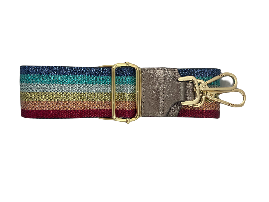 Rainbow Metallic Bagstrap, schouderband voor aan een tas met metallic rainbowprint. Deze schouderband heeft een lederen uiteinde in de kleur brons. De band is 5cm breed en is verstelbaar in de lengte. Minimale lengte , inclusief clips, is 84cm en de maximale lengte, inclusief clips is 125cm. De schouderband metallic is in verschillende kleuren verkrijgbaar: rainbow metallic en taupe/rosé/crème.